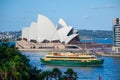 Green ferry boat in Sydney harbour with Opera house at the background. Royalty Free Stock Photo